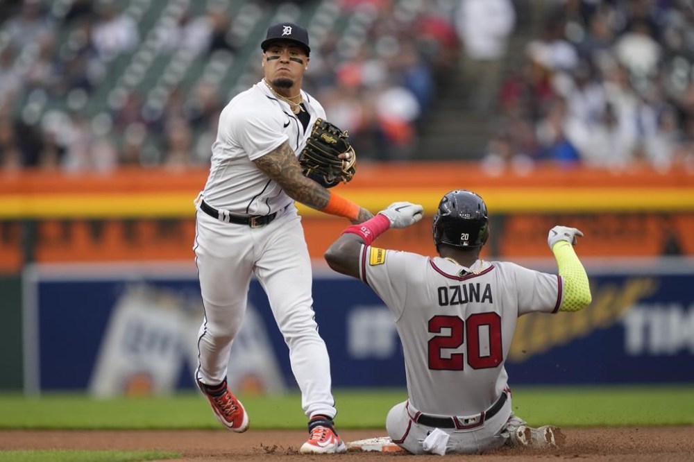 Atlanta Braves designated hitter Marcell Ozuna is out at second as Detroit Tigers shortstop Javier Baez completes the double play for the out on Eddie Rosario during the fourth inning of a baseball game, Monday, June 12, 2023, in Detroit. (AP Photo/Carlos Osorio)