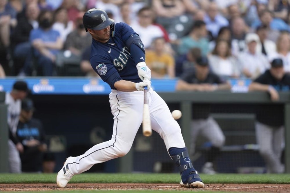 Seattle Mariners' Ty France hits a three-run home run off Miami Marlins starting pitcher Jesus Luzardo during the second inning of a baseball game, Monday, June 12, 2023, in Seattle. (AP Photo/Stephen Brashear)