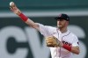 FILE - Boston Red Sox infielder Trevor Story throws to first base on the force out single by Texas Rangers' Marcus Semien during the third inning of a baseball game, Sept. 3, 2022, in Boston. Story thinks he can return to the lineup in July 2023 as the team’s designated hitter. Recovering from surgery in January on his injured right elbow, Story is in Boston working out with the Red Sox after doing much of his rehab work at the team’s complex in Fort Myers, Fla. (AP Photo/Michael Dwyer, File)