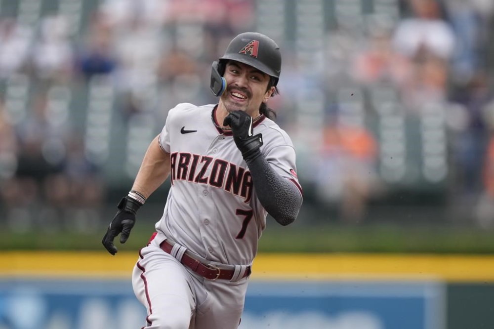 Arizona Diamondbacks left fielder Corbin Carroll runs safely to third during the first inning of a baseball game against the Detroit Tigers, Sunday, June 11, 2023, in Detroit. (AP Photo/Carlos Osorio)
