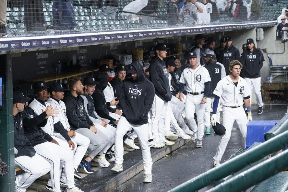 Detroit Tigers players sit in the dugout during a rain delay against the Atlanta Braves before a baseball game, Tuesday, June 13, 2023, in Detroit. (AP Photo/Paul Sancya)