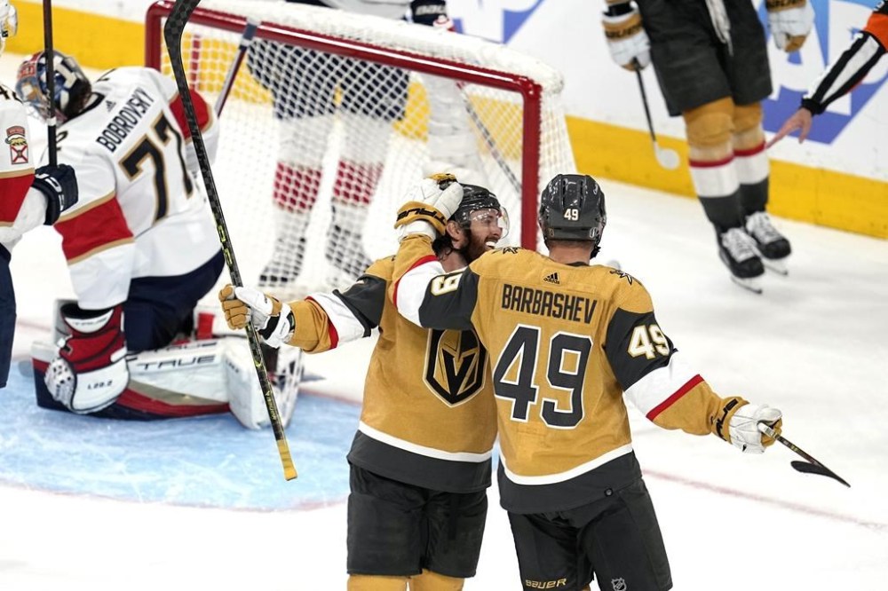 Vegas Golden Knights center Ivan Barbashev, right, celebrates his goal with right wing Jonathan Marchessault, second from right, as Florida Panthers goaltender Sergei Bobrovsky sits in goal during the third period in Game 5 of the NHL hockey Stanley Cup Finals Tuesday, June 13, 2023, in Las Vegas. (AP Photo/Abbie Parr)