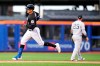New York Mets' Mark Canha passes New York Yankees' Gleyber Torres (25) as he runs the bases after hitting a home run during the first inning of a baseball game Tuesday, June 13, 2023, in New York. (AP Photo/Frank Franklin II)