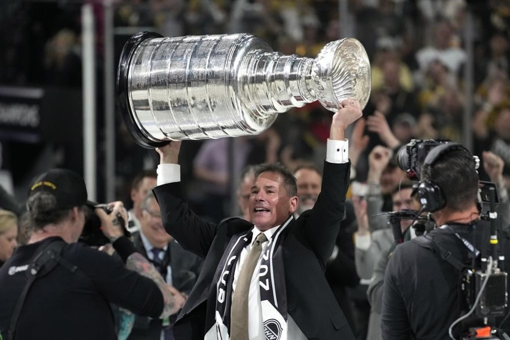 Vegas Golden Knights head coach Bruce Cassidy holds up the Stanley Cup after the Knights defeated the Florida Panthers 9-3 in Game 5 of the NHL hockey Stanley Cup Finals Tuesday, June 13, 2023, in Las Vegas. The Knights won the series 4-1. (AP Photo/John Locher)