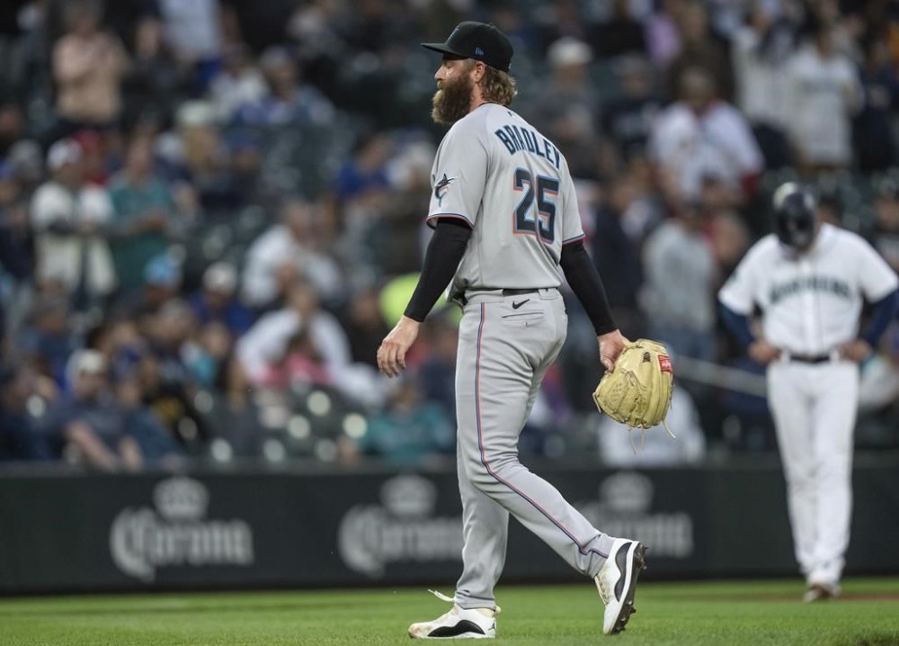Miami Marlins relief pitcher Archie Bradley walks off the field after being pulled by manager Skip Schumaker from the team's baseball game against the Seattle Mariners during the sixth inning, Tuesday, June 13, 2023, in Seattle. (AP Photo/Stephen Brashear)