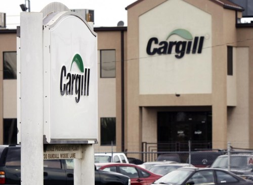 FILE - Cars sit parked at a Cargill Inc., turkey processing plant on Aug. 4, 2011, in Springdale, Ark. An activist group and researchers tried to increase pressure on agribusiness giant Cargill on Wednesday, June 14, 2023, to do more to fight deforestation and human rights abuse, releasing a report that accuses the company of not following through on commitments to help end such practices. (AP Photo/Danny Johnston, File)