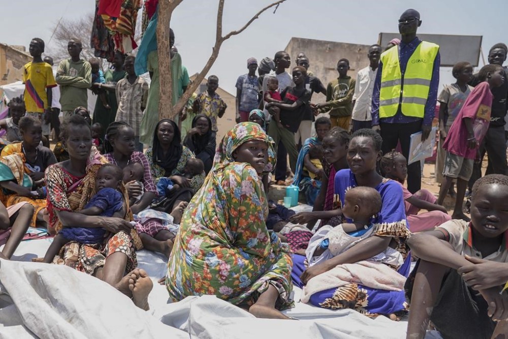FILE - South Sudanese who fled from Sudan sit outside a nutrition clinic at a transit center in Renk, South Sudan, May 16, 2023. The U.N. migration agency says Sudan’s conflict has displaced more than 2 million people as the tally of civilians killed in the fighting climbed to at least 959 people. Sudan has plunged into chaos since mid-April when monthslong tensions between the military and its rival, the paramilitary Rapid Support Forces, exploded into open fighting in the capital, Khartoum, and elsewhere across the northeastern African nation. The fighting has forced more than 1.6 million people to leave their homes for safer areas inside Sudan. (AP Photo/Sam Mednick, file)
