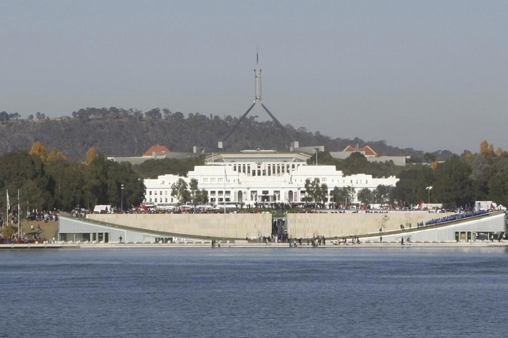 FILE - Australia's Parliament House sits behind Lake Burley Griffin in Canberra, Australia, Thursday, April 24, 2008. The Australian government expects to introduce legislation on Thursday, June 14, 2023, to prevent Russia from building a new embassy near Parliament House on security grounds. (AP Photo/Rob Griffith, File)