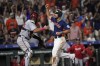 Houston Astros' Jose Abreu, right, celebrates as he scores the game-winning run as Washington Nationals catcher Keibert Ruiz looks back during the ninth inning of a baseball game Wednesday, June 14, 2023, in Houston. The Astros won 5-4. (AP Photo/David J. Phillip)