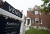 Real estate signage showing a home that has sold is seen on Monday, May 15, 2023 in Montreal. The Canadian Real Estate Association says home sales in May climbed higher compared with the same month last year to post the first year-over-year sales increase since June 2021 as prices also climbed higher. THE CANADIAN PRESS/Christinne Muschi