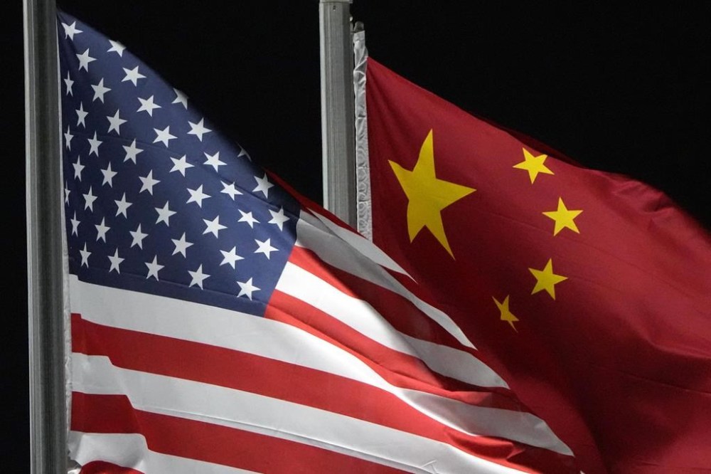 FILE - The American and Chinese flags wave at Genting Snow Park ahead of the 2022 Winter Olympics, in Zhangjiakou, China, on Feb. 2, 2022. Hackers linked to China were likely behind the exploitation of a software security hole in cybersecurity firm Barracuda Networks’ email security feature that affected public and private organizations globally, according to an investigation by security firm Mandiant. (AP Photo/Kiichiro Sato, File)