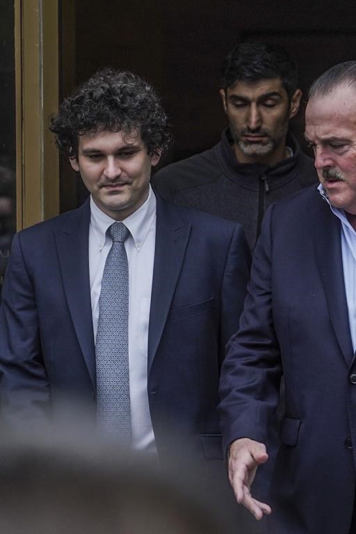 FTX founder Sam Bankman-Fried, left, leaves Manhattan federal court, Thursday June 15, 2023, in New York. Bankman-Fried's lawyers encountered a skeptical federal judge when they argued that he should toss out criminal fraud charges their client faces after the collapse of his cryptocurrency business.(AP Photo/Bebeto Matthews)