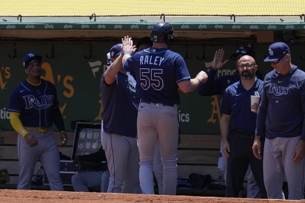 Tampa Bay Rays' Luke Raley (55) celebrates with teammates at the dugout after scoring against the Oakland Athletics on Taylor Walls' double during the second inning of a baseball game in Oakland, Calif., Thursday, June 15, 2023. (AP Photo/Godofredo A. Vásquez)