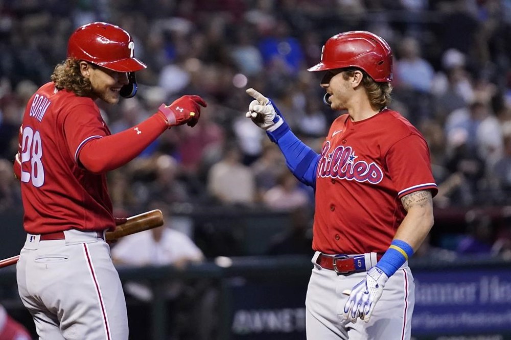 Philadelphia Phillies' Bryson Stott, right, celebrates after his home run against the Arizona Diamondbacks with Phillies' Alec Bohm (28) during the second inning of a baseball game Thursday, June 15, 2023, in Phoenix. (AP Photo/Ross D. Franklin)