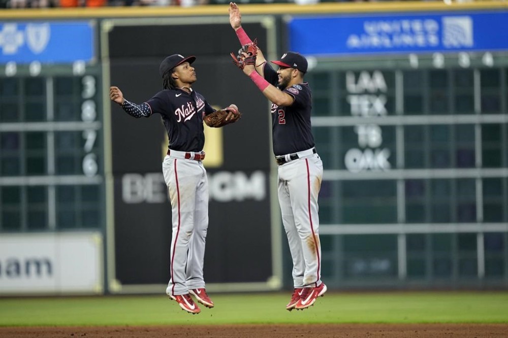 Washington Nationals' CJ Abrams (5) and Luis Garcia (2) celebrate after a baseball game against the Houston Astros Thursday, June 15, 2023, in Houston. The Nationals won 4-1 in 10 innings. (AP Photo/David J. Phillip)