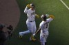 San Diego Padres' Manny Machado, left, celebrates with teammate Xander Bogaerts after hitting a three-run home run during the first inning of a baseball game against the Cleveland Guardians, Thursday, June 15, 2023, in San Diego. (AP Photo/Gregory Bull)