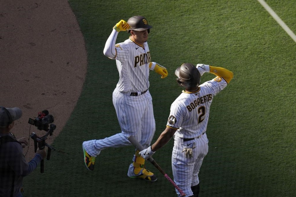 San Diego Padres' Manny Machado, left, celebrates with teammate Xander Bogaerts after hitting a three-run home run during the first inning of a baseball game against the Cleveland Guardians, Thursday, June 15, 2023, in San Diego. (AP Photo/Gregory Bull)