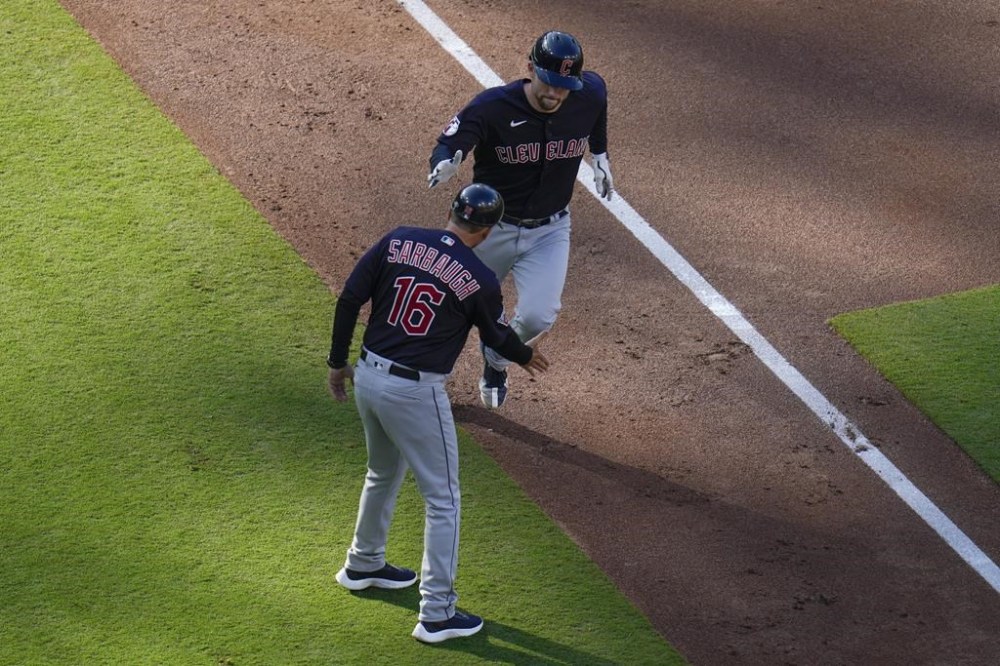 Cleveland Guardians' David Fry, right, is greeted by third base coach Mike Sarbaugh (16) after hitting a three-run home run during the first inning of a baseball game against the San Diego Padres, Thursday, June 15, 2023, in San Diego. (AP Photo/Gregory Bull)