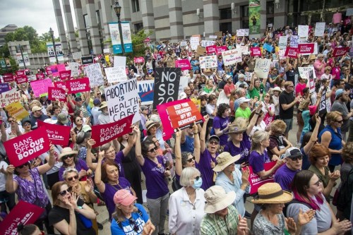 FILE - Hundreds of abortion ban veto supporters turned out to watch North Carolina Gov. Roy Cooper sign a veto of the on Bicentennial Mall in Raleigh Saturday, May 19, 2023. Abortion providers in North Carolina filed a federal lawsuit Friday, June 16, 2023, that challenges several provisions of a state law banning most abortions after 12 weeks of pregnancy in the dwindling days before the new restrictions take effect.(Travis Long/The News & Observer via AP, File)