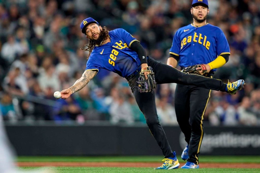 Seattle Mariners shortstop J.P. Crawford throws to first on a single by Chicago White Sox's Tim Anderson during the fourth inning of a baseball game, Friday, June 16, 2023, in Seattle. (AP Photo/John Froschauer)