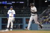 San Francisco Giants' Wilmer Flores, right, rounds second after hitting a two-run home run as Los Angeles Dodgers second baseman Miguel Vargas watches during the seventh inning of a baseball game Friday, June 16, 2023, in Los Angeles. (AP Photo/Mark J. Terrill)