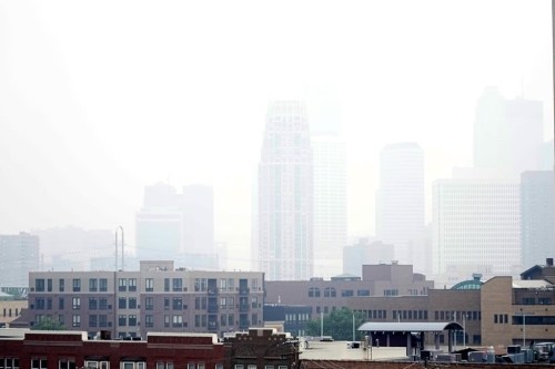Haze envelopes the Minneapolis skyline from smoke drifted over from the wildfires in Canada, Wednesday, June 14, 2023, in Minneapolis. An air quality alert has been issued for some parts of Minnesota. THE CANADIAN PRESS/AP-Abbie Parr