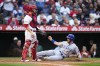 Chicago Cubs' Patrick Wisdom (16) scores on a double by Matt Mervis, next to Los Angeles Angels catcher Matt Thaiss during the second inning of a baseball game Tuesday, June 6, 2023, in Anaheim, Calif. (AP Photo/Jae C. Hong)