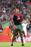 A pitch invader catches Portugal's Cristiano Ronaldo during the Euro 2024 group J qualifying soccer match between Portugal and Bosnia and Herzegovina, at the Luz Stadium in Lisbon, Portugal, Saturday, June 17, 2023. (AP Photo/Armando Franca)