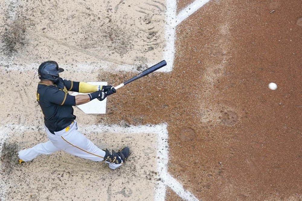 Pittsburgh Pirates' Carlos Santana hits a single during the seventh inning of a baseball game against the Milwaukee Brewers Saturday, June 17, 2023, in Milwaukee. (AP Photo/Morry Gash)