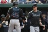 Miami Marlins' Jonathan Davis (49) celebrates with manager Skip Schumaker, right, after hitting a sacrifice fly that scored Jesús Sánchez during the second inning of a baseball game against the Washington Nationals, Saturday, June 17, 2023, in Washington. (AP Photo/Luis M. Alvarez)