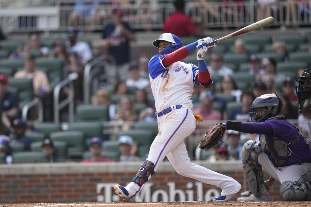 Atlanta Braves' Orlando Arcia (11) hits a solo home run in the third inning of a baseball game against the Colorado Rockies, Saturday, June 17, 2023, in Atlanta. (AP Photo/Brynn Anderson)