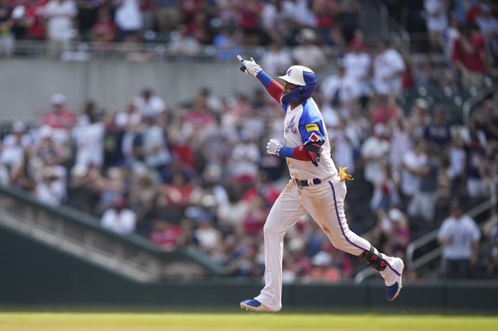 Atlanta Braves' Orlando Arcia (11) celebrates after hitting a solo home run in the third inning of a baseball game against the Colorado Rockies, Saturday, June 17, 2023, in Atlanta. (AP Photo/Brynn Anderson)