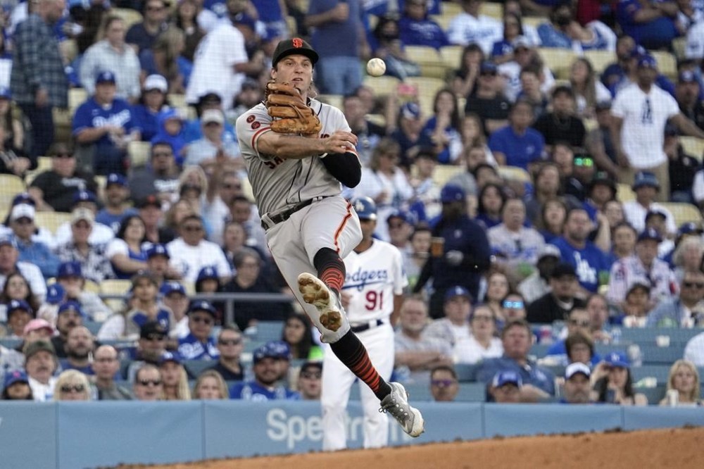 San Francisco Giants third baseman Casey Schmitt attempts to throw out Los Angeles Dodgers' Jonny Deluca at first during the second inning of a baseball game Saturday, June 17, 2023, in Los Angeles. Deluca was safe at first on the play. (AP Photo/Mark J. Terrill)
