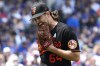 Baltimore Orioles starting pitcher Dean Kremer bites his glove while he walks back to the dugout after the fourth inning of a baseball game against the Chicago Cubs in Chicago, Sunday, June 18, 2023. (AP Photo/Nam Y. Huh)