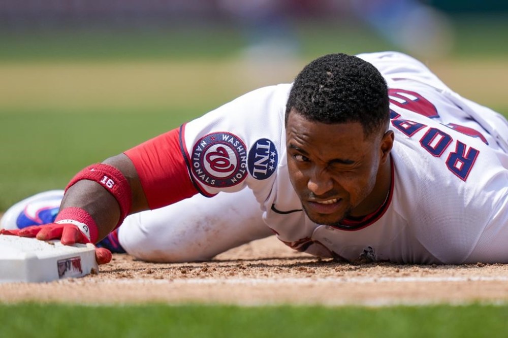 Washington Nationals' Victor Robles reacts after he was picked off on first base during the fifth inning of a baseball game against the Miami Marlins at Nationals Park, Sunday, June 18, 2023, in Washington. (AP Photo/Alex Brandon)