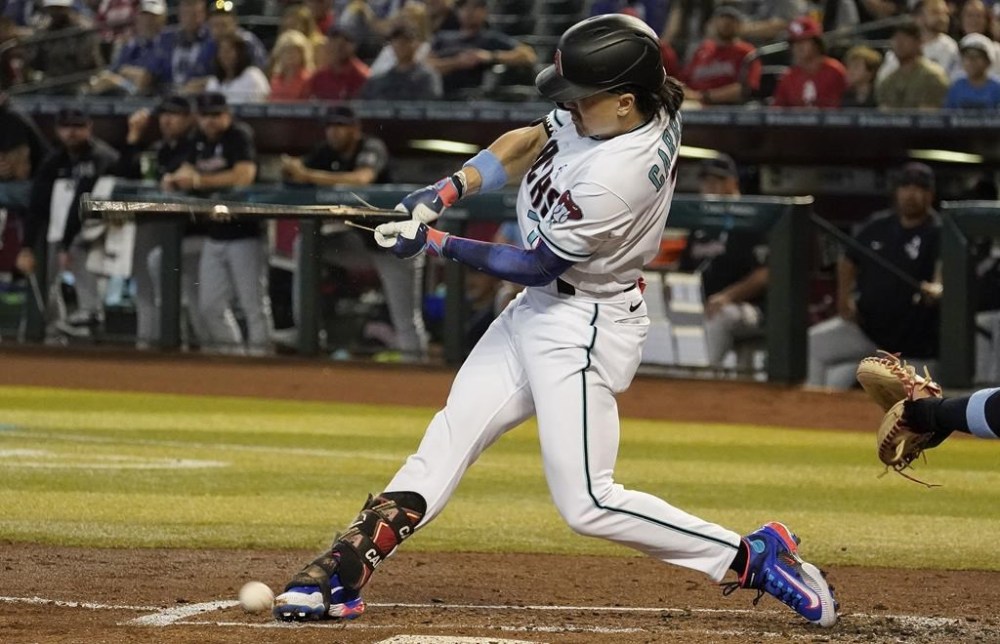 Arizona Diamondbacks' Corbin Carroll breaks his bat against the Cleveland Guardians during the first inning of a baseball game, Sunday, June 18, 2023, in Phoenix. (AP Photo/Darryl Webb)