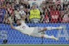 Spain goalkeeper Unai Simon stops a penalty shot from Croatia's Bruno Petkovic during a penalty shootout at the end of the Nations League final soccer match between Croatia and Spain at De Kuip stadium in Rotterdam, Netherlands, Sunday, June 18, 2023. Spain won 5-4 in a penalty shootout after the match ended tied 0-0. (AP Photo/Peter Dejong)