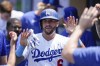 Los Angeles Dodgers' David Peralta (6) celebrates in the dugout after scoring off of a single hit by James Outman during the fourth inning of a baseball game against the San Francisco Giants in Los Angeles, Sunday, June 18, 2023. (AP Photo/Ashley Landis)