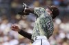 San Diego Padres' Joe Musgrove attempts to field a ball hit by Tampa Bay Rays' Randy Arozarena in the fourth inning of a baseball game Sunday, June 18, 2023, in San Diego. Rays' Luke Raley advanced to third on the play. (AP Photo/Derrick Tuskan)