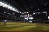 Home plate umpire Pat Hoberg has the field to himself as a lighting issue causes an interruption in play in the first inning of a baseball game between the Arizona Diamondbacks and the Cleveland Guardians, Sunday, June 18, 2023, in Phoenix. (AP Photo/Darryl Webb)
