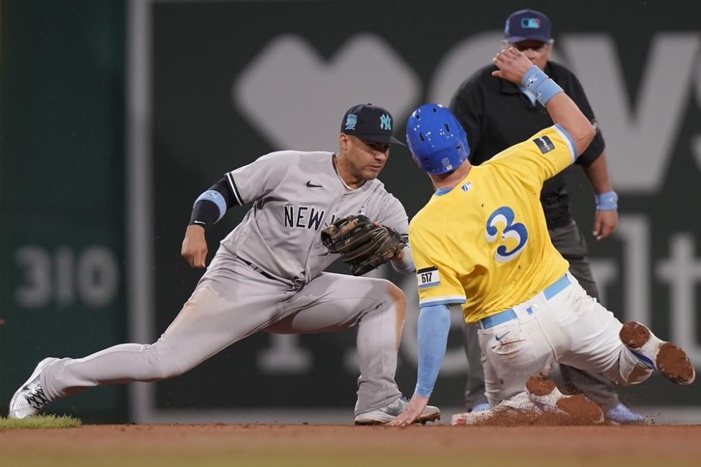 Boston Red Sox's Reese McGuire (3) slides out against New York Yankees' Gleyber Torres, left, while trying to steal second base in the sixth inning of the second game of a baseball doubleheader, Sunday, June 18, 2023, in Boston. (AP Photo/Steven Senne)