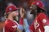 Cincinnati Reds' Elly De La Cruz (44) and Jake Fraley celebrate after a baseball game against the Houston Astros Sunday, June 18, 2023, in Houston. The Reds won 9-7 in 10 innings. (AP Photo/David J. Phillip)