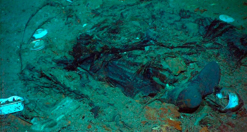 This 2004 photo provided by the Institute for Exploration, Center for Archaeological Oceanography/University of Rhode Island/NOAA Office of Ocean Exploration, shows the remains of a coat and boots in the mud on the sea bed near the Titanic's stern. (Institute for Exploration, Center for Archaeological Oceanography/University of Rhode Island/NOAA Office of Ocean Exploration, File)