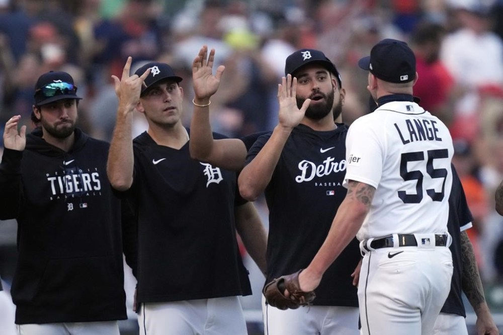 Detroit Tigers relief pitcher Alex Lange is greeted by teammates after the ninth inning of a baseball game against the Kansas City Royals, Monday, June 19, 2023, in Detroit. (AP Photo/Carlos Osorio)
