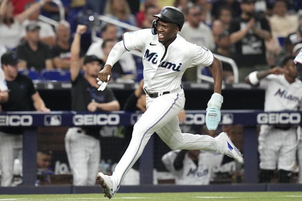Miami Marlins' Jesus Sanchez runs home to score on a single hit by Garrett Cooper during the third inning of a baseball game against the Toronto Blue Jays, Monday, June 19, 2023, in Miami. (AP Photo/Lynne Sladky)