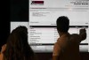People look at federal by-election results after polls closed in the Notre-Dame-de-Grace-Westmount riding of Montreal, Monday, June 19, 2023. THE CANADIAN PRESS/Christinne Muschi