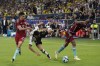 Germany's Jamal Musiala, center, is challenged by Colombia's Daniel Munoz, left, and Colombia's Juan Cuadrado during an international friendly soccer match between Germany and Colombia at Veltins-Arena, in Gelsenkirchen, Germany, Tuesday, June 20, 2023. (AP Photo/Martin Meissner)