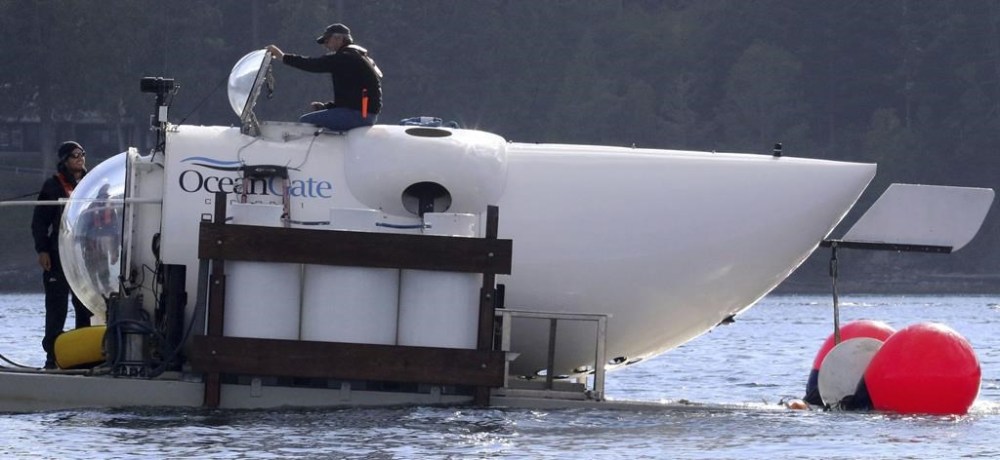 OceanGate CEO Stockton Rush emerges from the hatch atop the OceanGate submarine Cyclops 1 in the San Juan Islands, Wash., on Sept. 12, 2018. Rescuers in a remote area of the Atlantic Ocean raced against time Tuesday to find a missing submersible before the oxygen supply runs out for five people, including Stockton, who were on a mission to document the wreckage of the Titanic. (Alan Berner/The Seattle Times via AP)