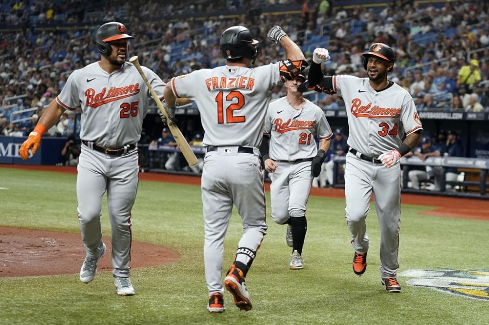 Baltimore Orioles' Aaron Hicks (34) celebrates with Adam Frazier (12), Austin Hays (21), and Anthony Santander (25) after his three-run home run off Tampa Bay Rays starting pitcher Tyler Glasnow during the first inning of a baseball game Tuesday, June 20, 2023, in St. Petersburg, Fla. (AP Photo/Chris O'Meara)