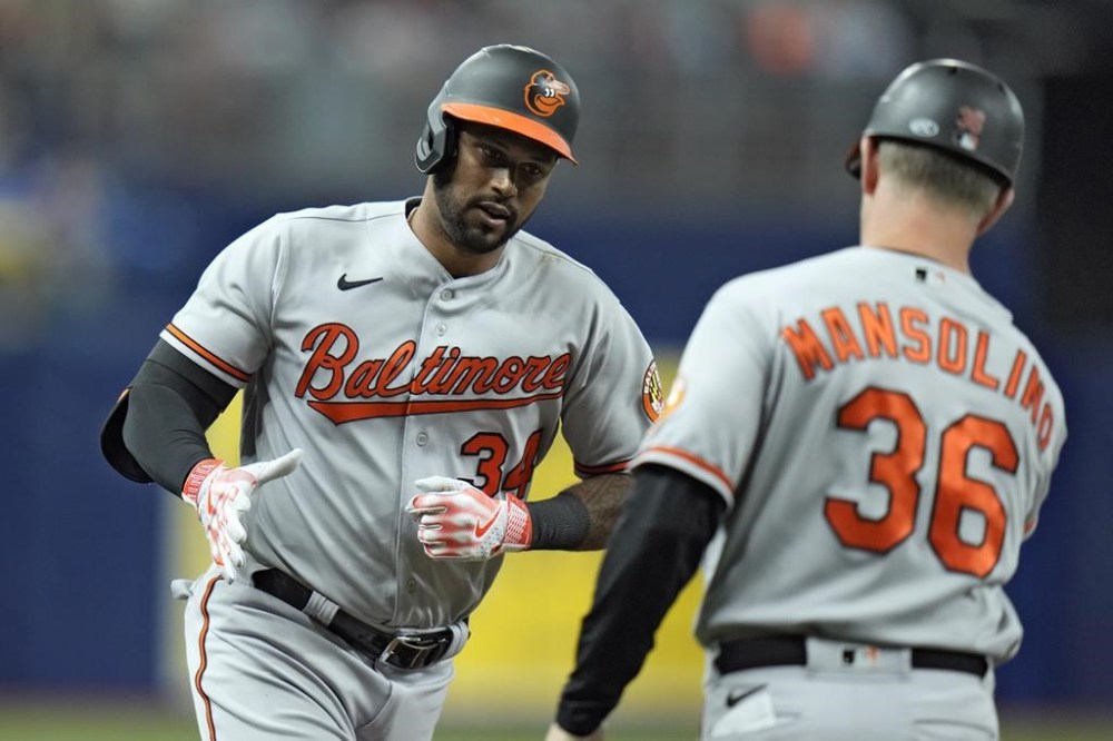 Baltimore Orioles' Aaron Hicks (34) celebrates with third base coach Tony Mansolino (36) after his three-run home run off Tampa Bay Rays starting pitcher Tyler Glasnow during the first inning of a baseball game Tuesday, June 20, 2023, in St. Petersburg, Fla. (AP Photo/Chris O'Meara)